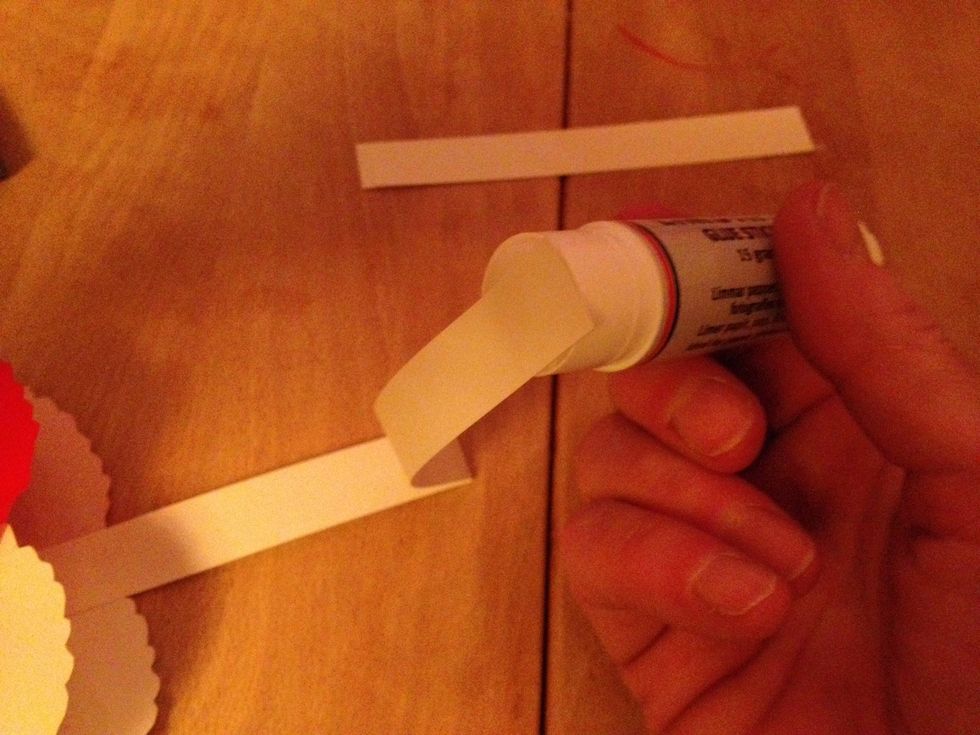 Glue a strip of paper to the heart as a handle.