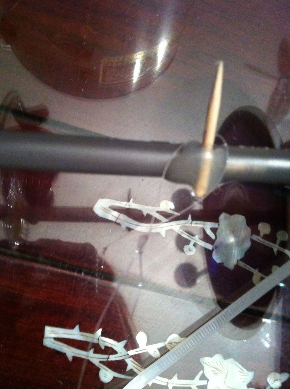 Glue a toothpick to the final wheel in the back of the car on its Pen body make a loop with the fishing line and place on toothpick