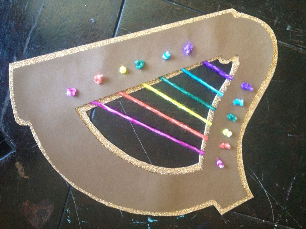 glue brown piece with strings to the gold piece and place beneath something heavy - I prefer high school yearbooks!