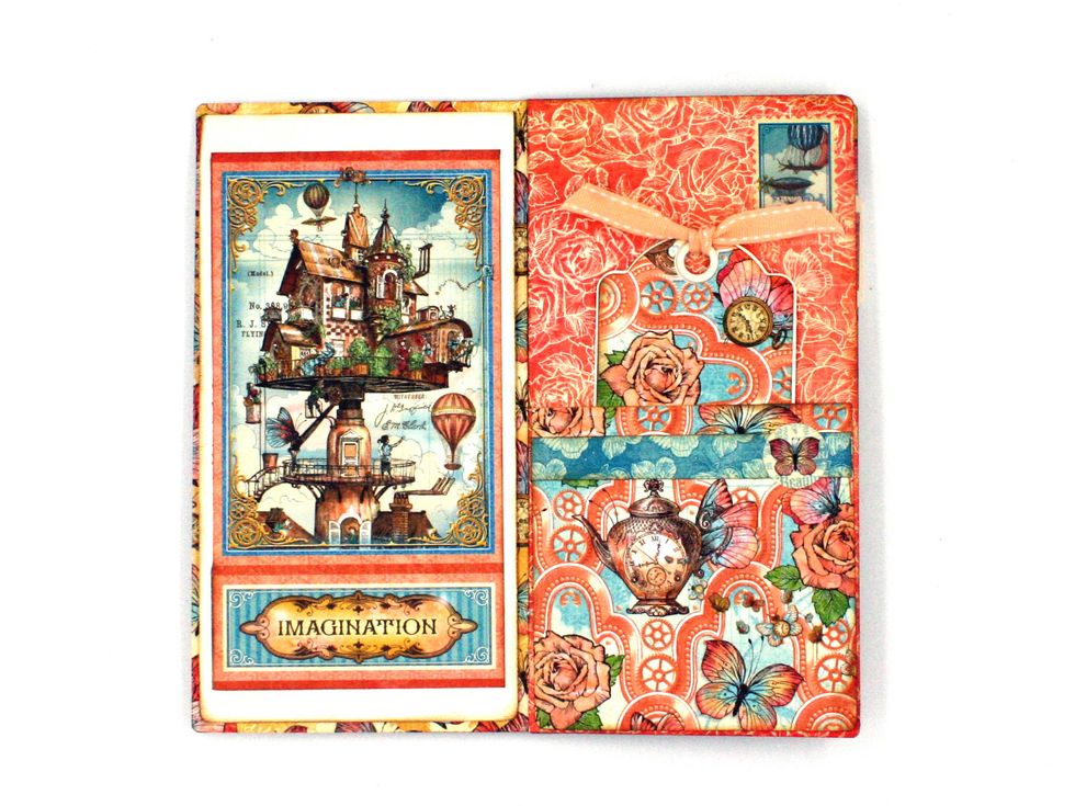 Glue cut-aparts as shown from Castles in the Air to the cardstock flap made in step 38.  Create a 4" sq. pocket on the next page as shown.  Add a stamp sticker at the top.
