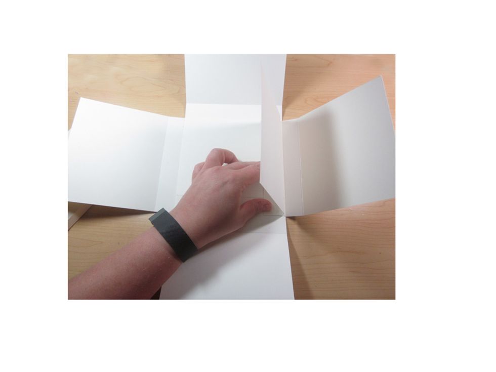 Glue down just on the first crease line of the inside square.