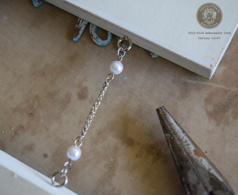 Glue down painted words and Relics & Artifacts\u00ae pieces. Attach frames using decorative chains or trims.