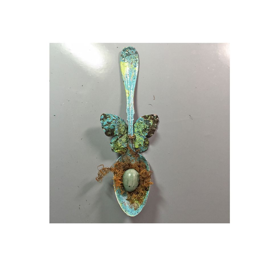 Glue down some moss and a egg to the bowl of the spoon.