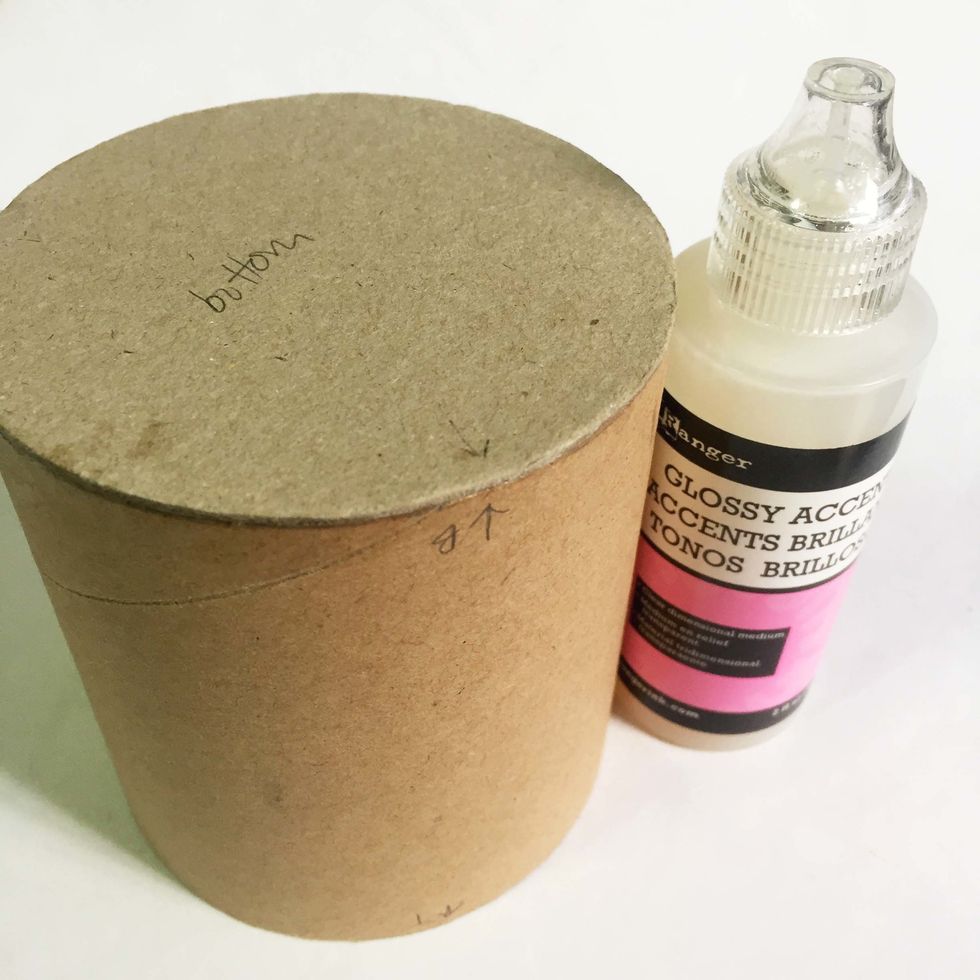 Glue down the bottom base onto the toilet roll using glossy accents. You may want to use other tacky/white glue if you find it a better option.