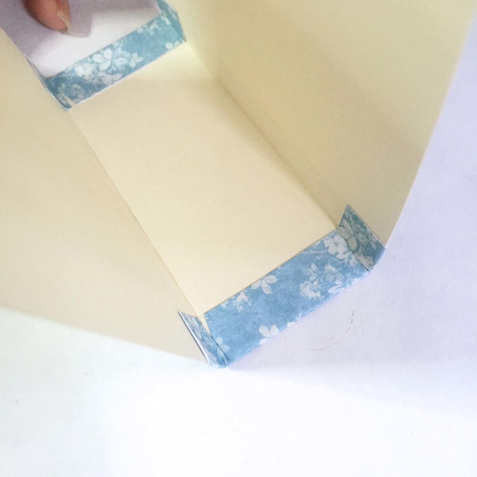 Glue down the tabs on both end on the inside of the base. Fold and adjust when necessary.