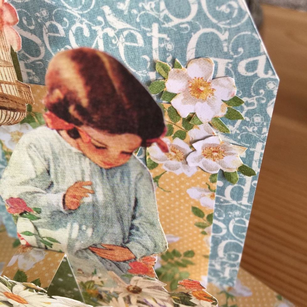 Glue flowers on the edge between the two different designe papers to unify.