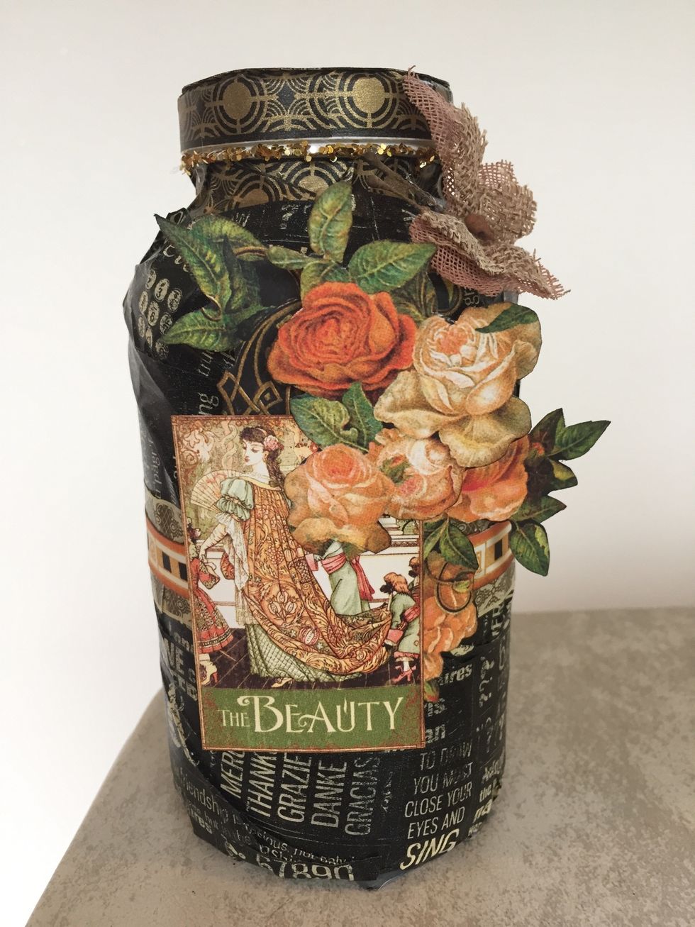 Glue half of the larger flower image first. Attach foam dots behind "Beauty" image and adhere. Glue second set of flowers on top of "Beauty" image. Glue butterfly above the flowers.