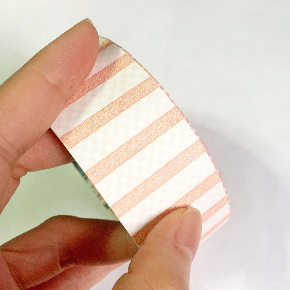 Glue it around the surface of the rim of the lid.