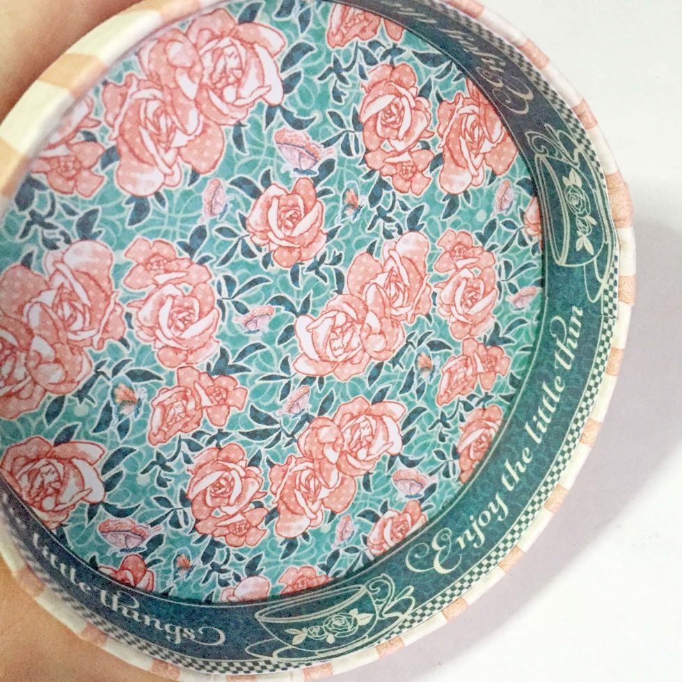 Glue it down onto the inner rim of the lid.