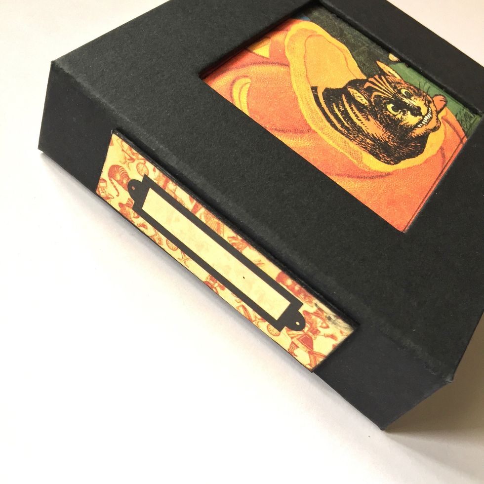 Glue it on a cardboard, ink edges and glue to the spine album.
