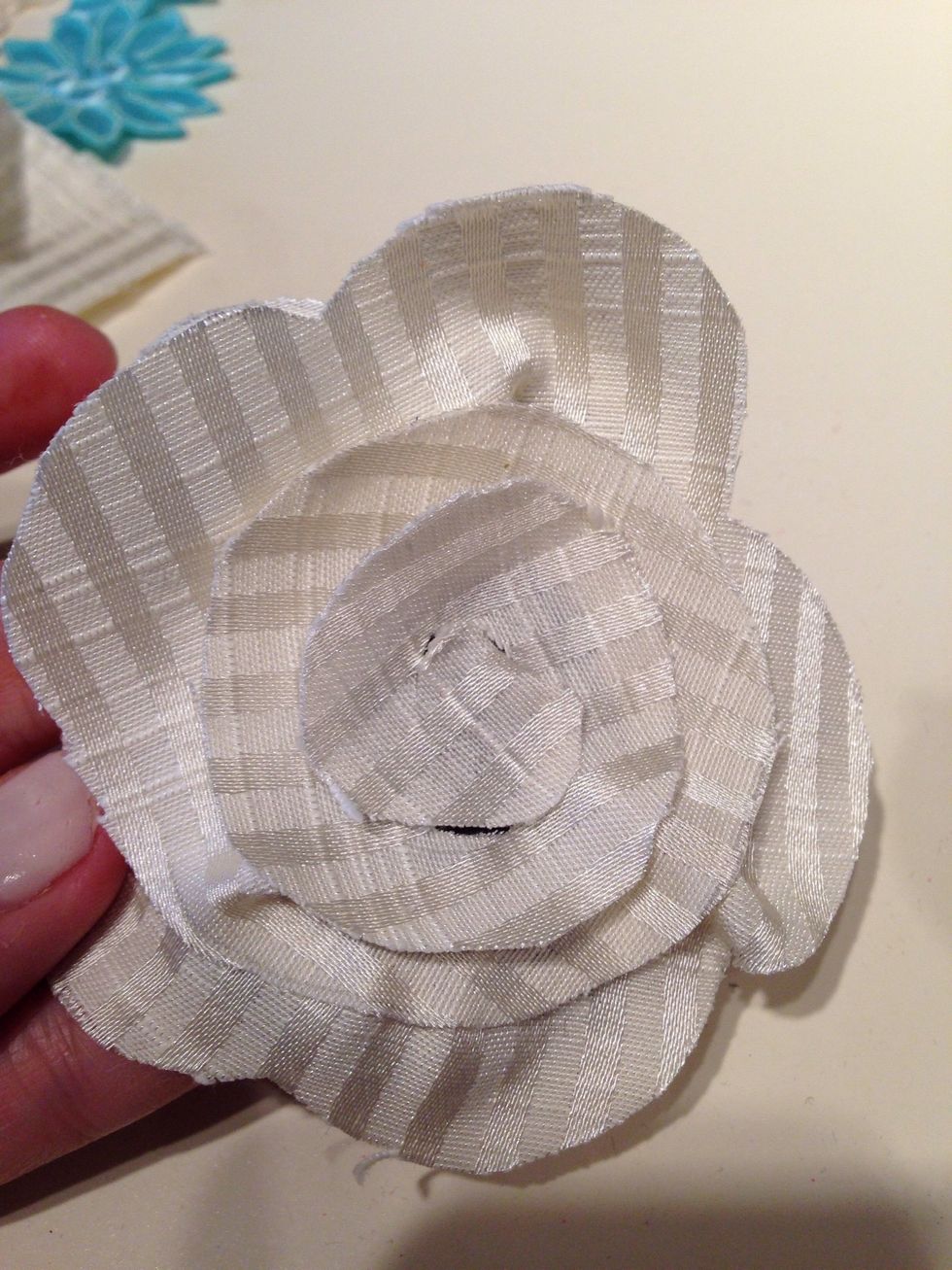 Glue it the same way, all the way down to the center swirl. Then add a button in the middle.