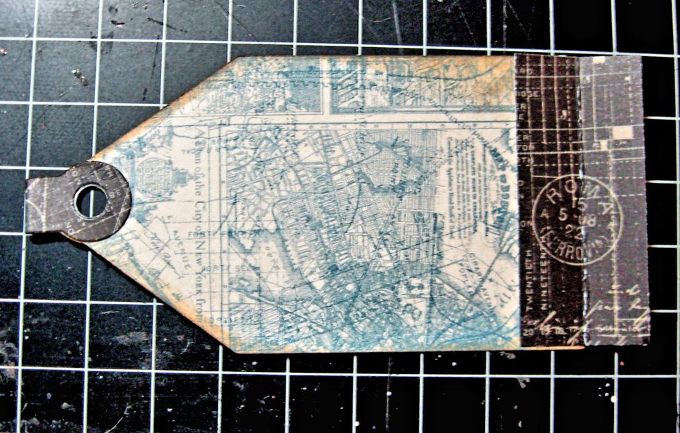 Glue left hand side of binding to the right hand side of the inside cover, as seen here. The bow is on the outside of the binding, not glued inside the binding.