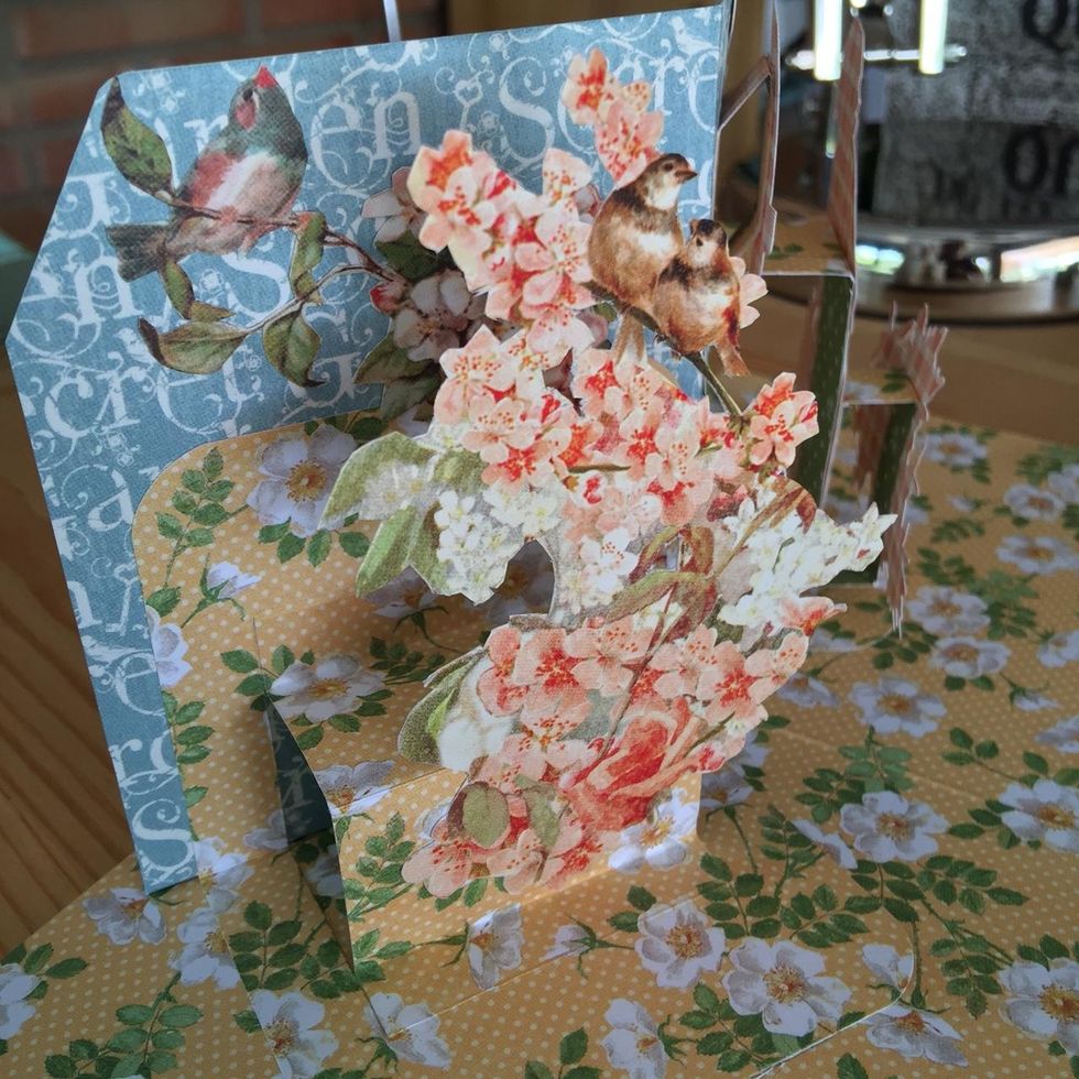 Glue more fussy cut pieces on the left side.