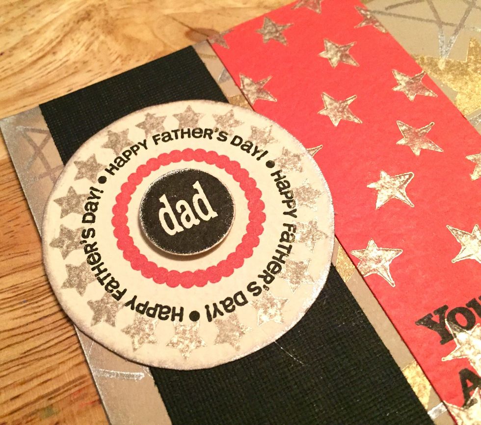 glue on cream circle about 1/2" from top of black banner, then add "dad" circle using a 3D dot.