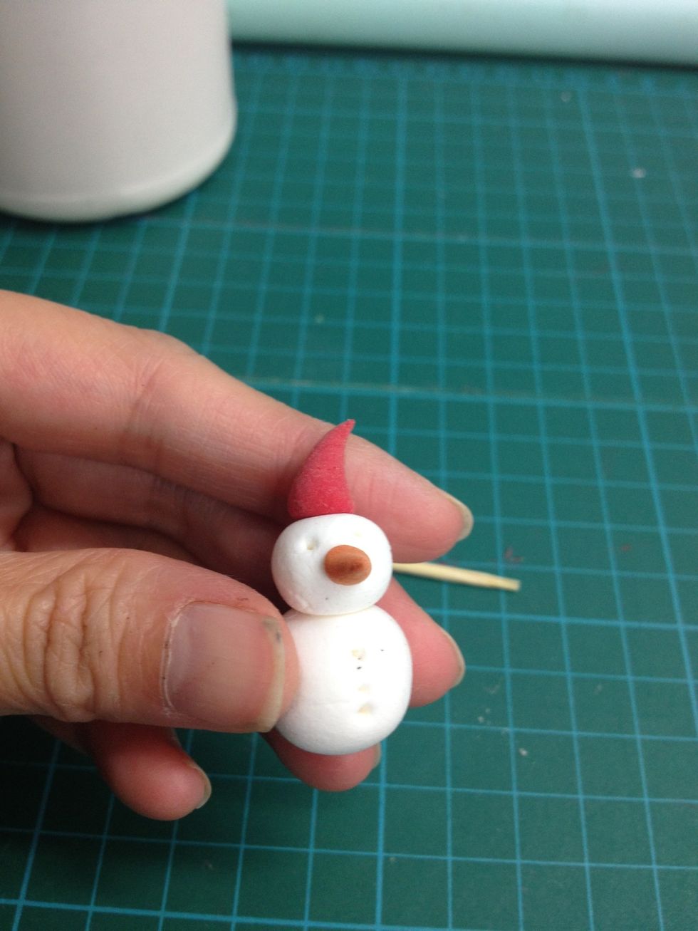 Glue on the head to finish the snowman.