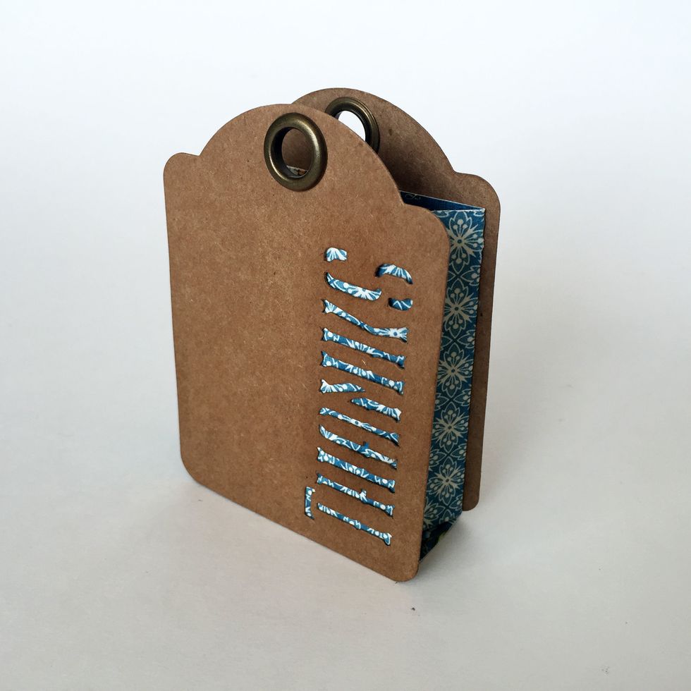 Glue one \u2018Thanks\u2019 tag to the front of the bag and one on the back. Make sure to line the the bottom of the tags with the bottom of the bag.