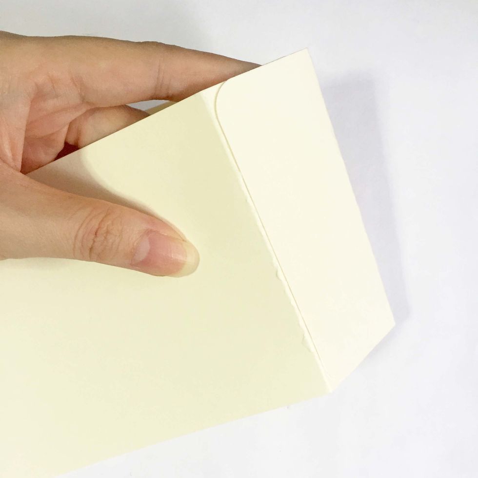 Glue over the other tag as shown. This will be the base of the box.
