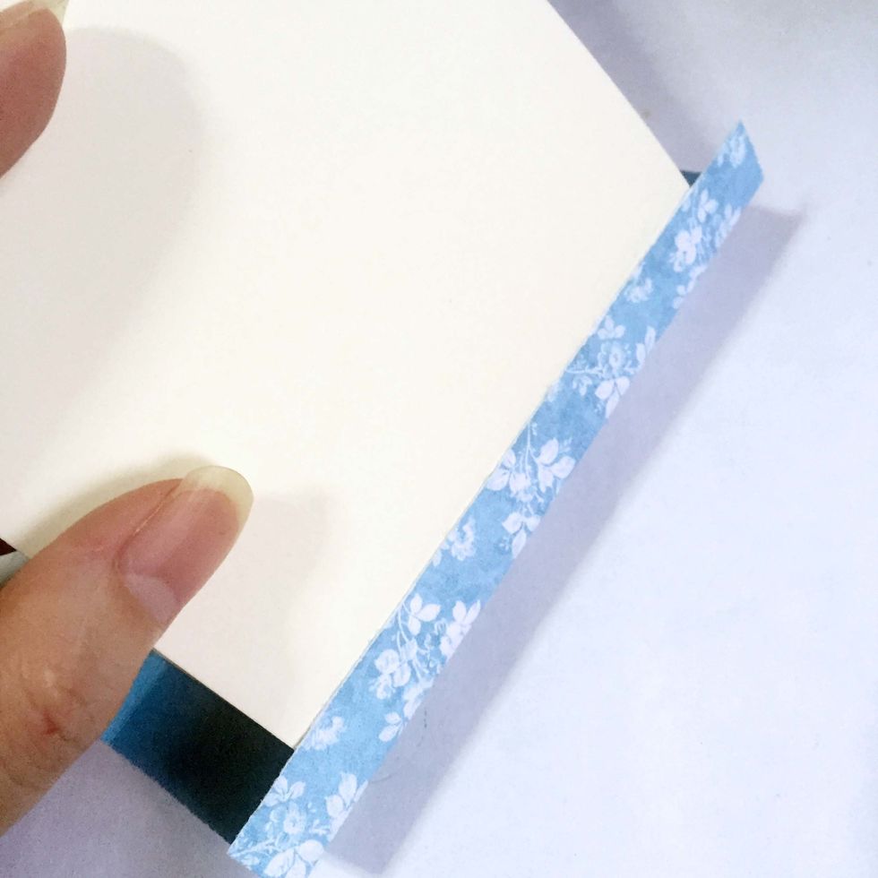 Glue over the surface of the tag as shown. Repeat on the other side of the tag.