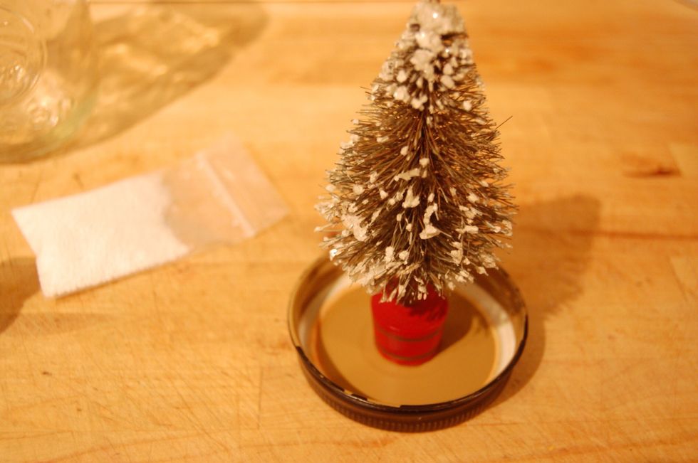 Glue, place, and stick your plastic figurine to the inside of the jar lid.