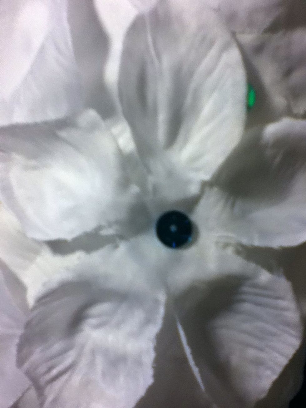 Glue sequins on the centers of the petals that are visible to hide them and to add color