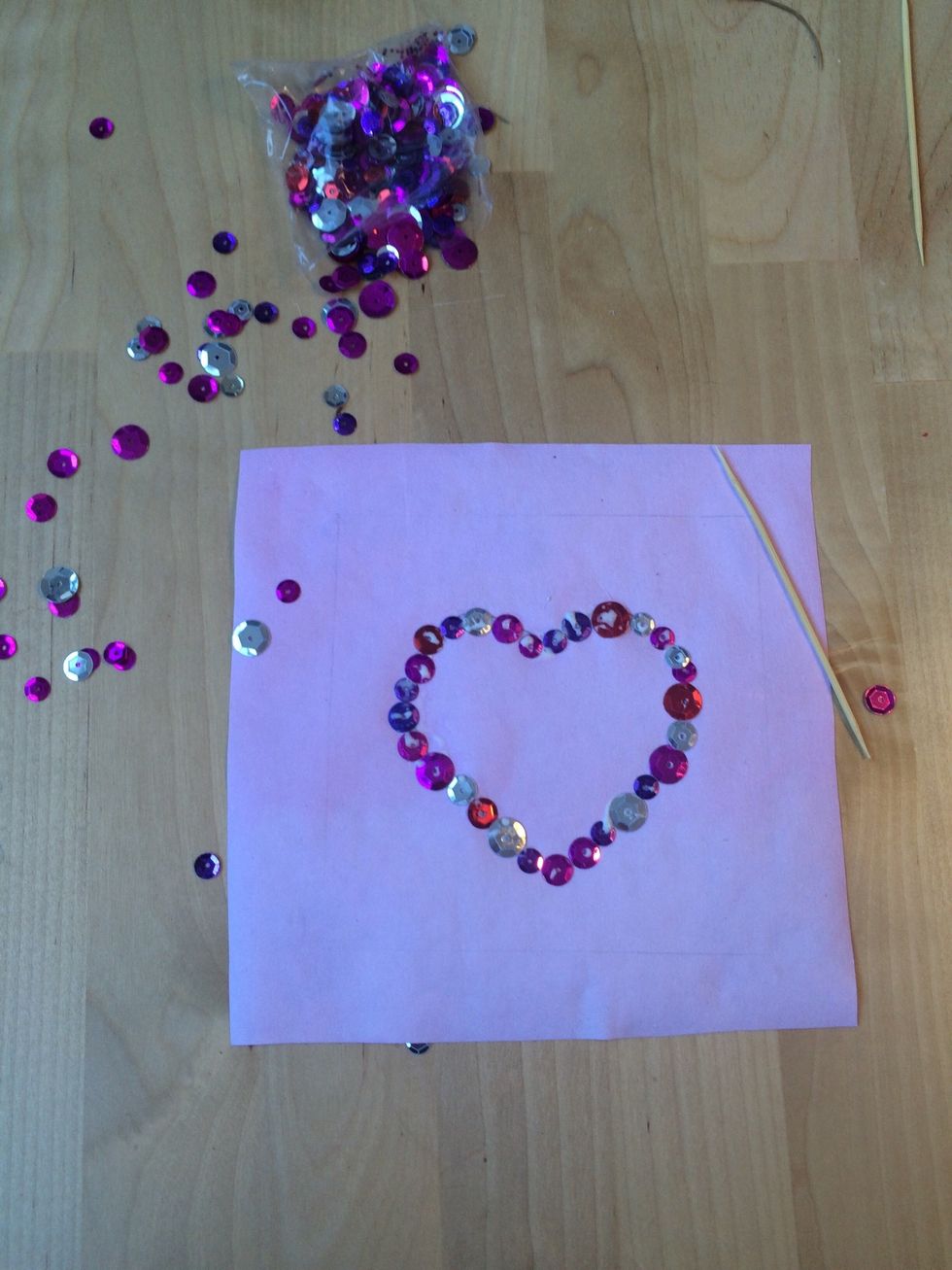Glue sequins over the outline. It helps to use a toothpick to line up the sequins.