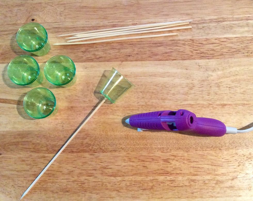 Glue skewers to shot glasses (or any other goodies you may be using for your bouquet.) Don't be afraid to cut some of the skewers. Remember, a bouquet needs different length stems!