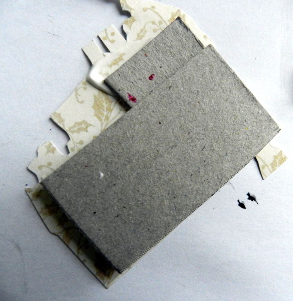 Glue some chipboard scraps behind the house cut.