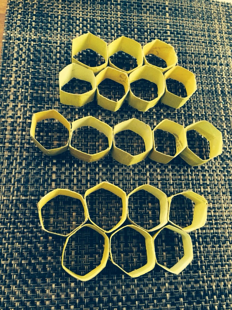 Glue the 5 hexagon piece row to each 4 piece row. Both sides of the 5 hexagon row should have a 4 piece row connected on top and bottom. You know have finished the honeycomb part.