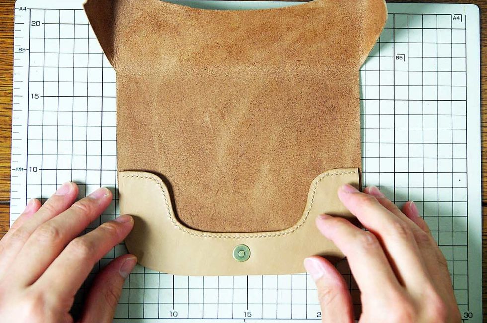 Glue the belt together using elastomeric adhesive which is used to glue leather.