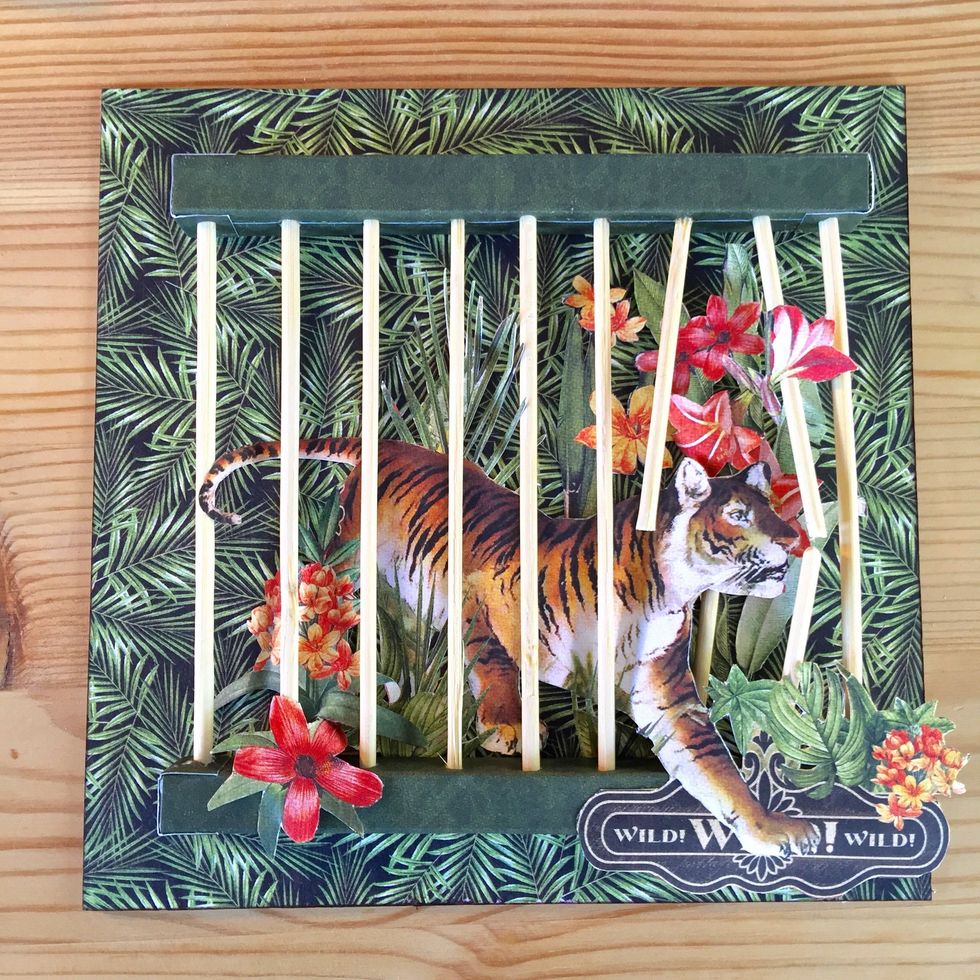 Glue the cage on the paper.