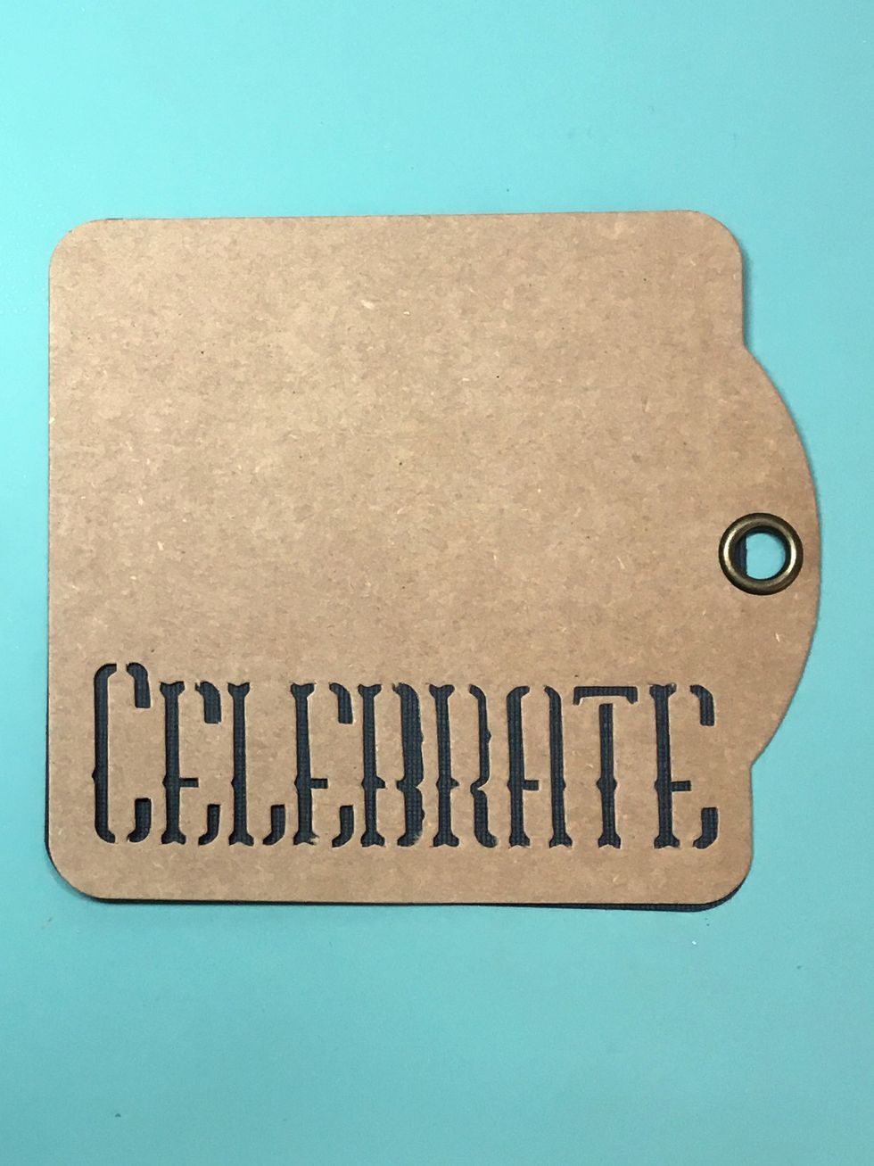Glue the cardstock to the back of the Celebrate tag. This will be the front cover of the mini.