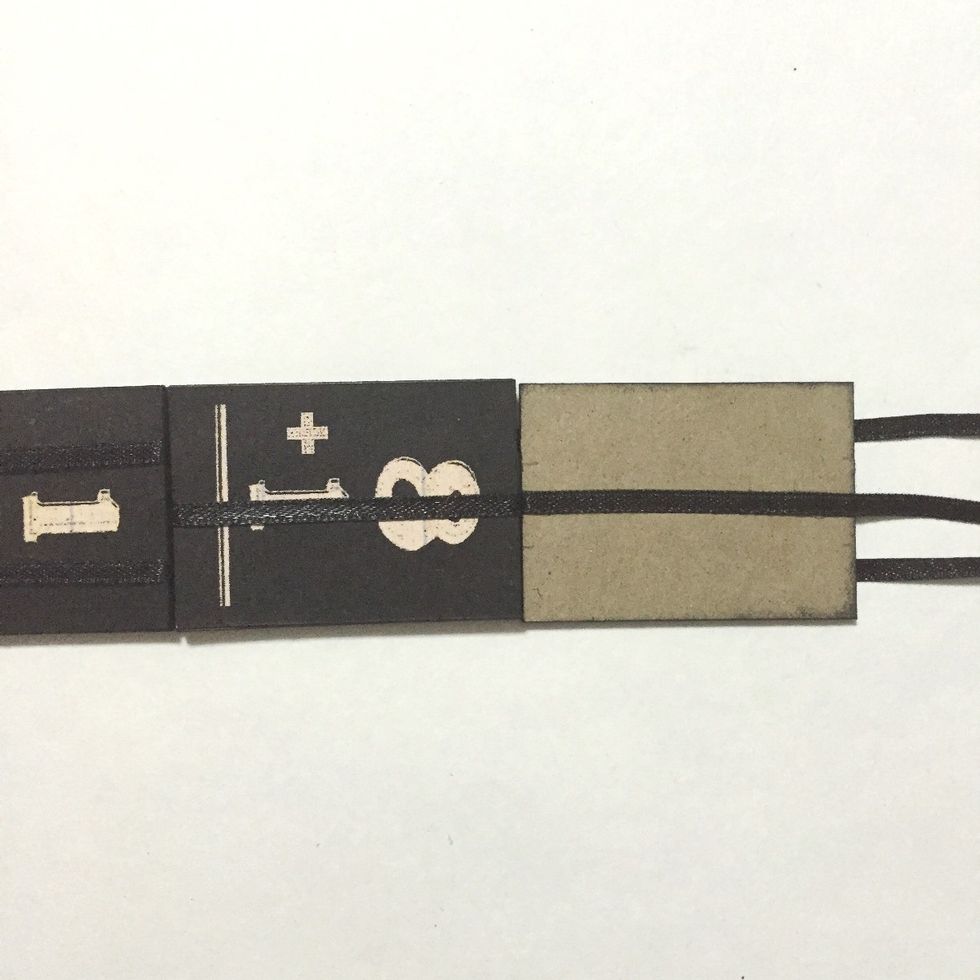 Glue the center ribbon over the 5th number block as shown, leaving the 2 ribbons underneath...