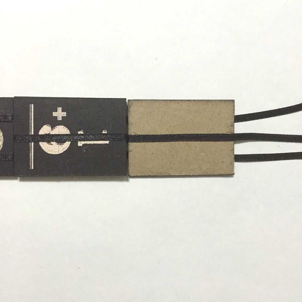 Glue the center ribbon over the 9th number block as shown, leaving the 2 ribbons underneath...