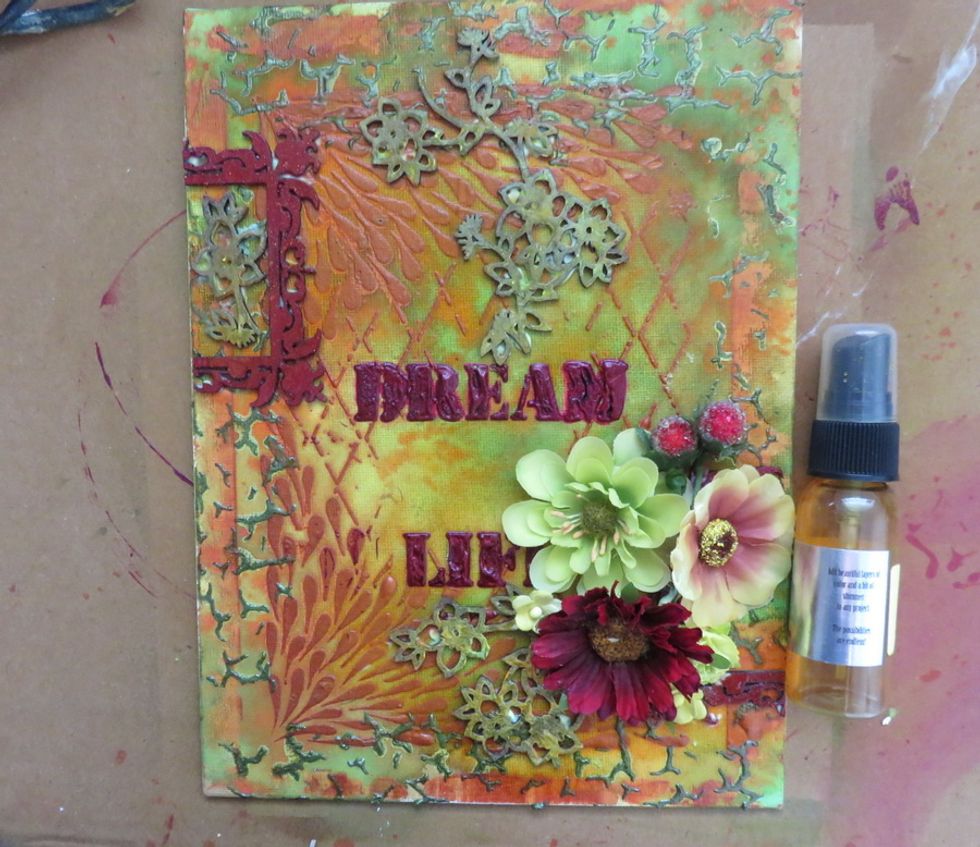 Glue the chipboards and the flowers as shown and spray with Glorious Colorations all over the piece.