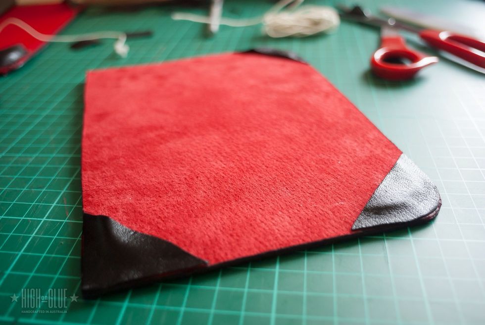 Glue the corners on the inside cover and cut off the excess leather at the rounded corners.