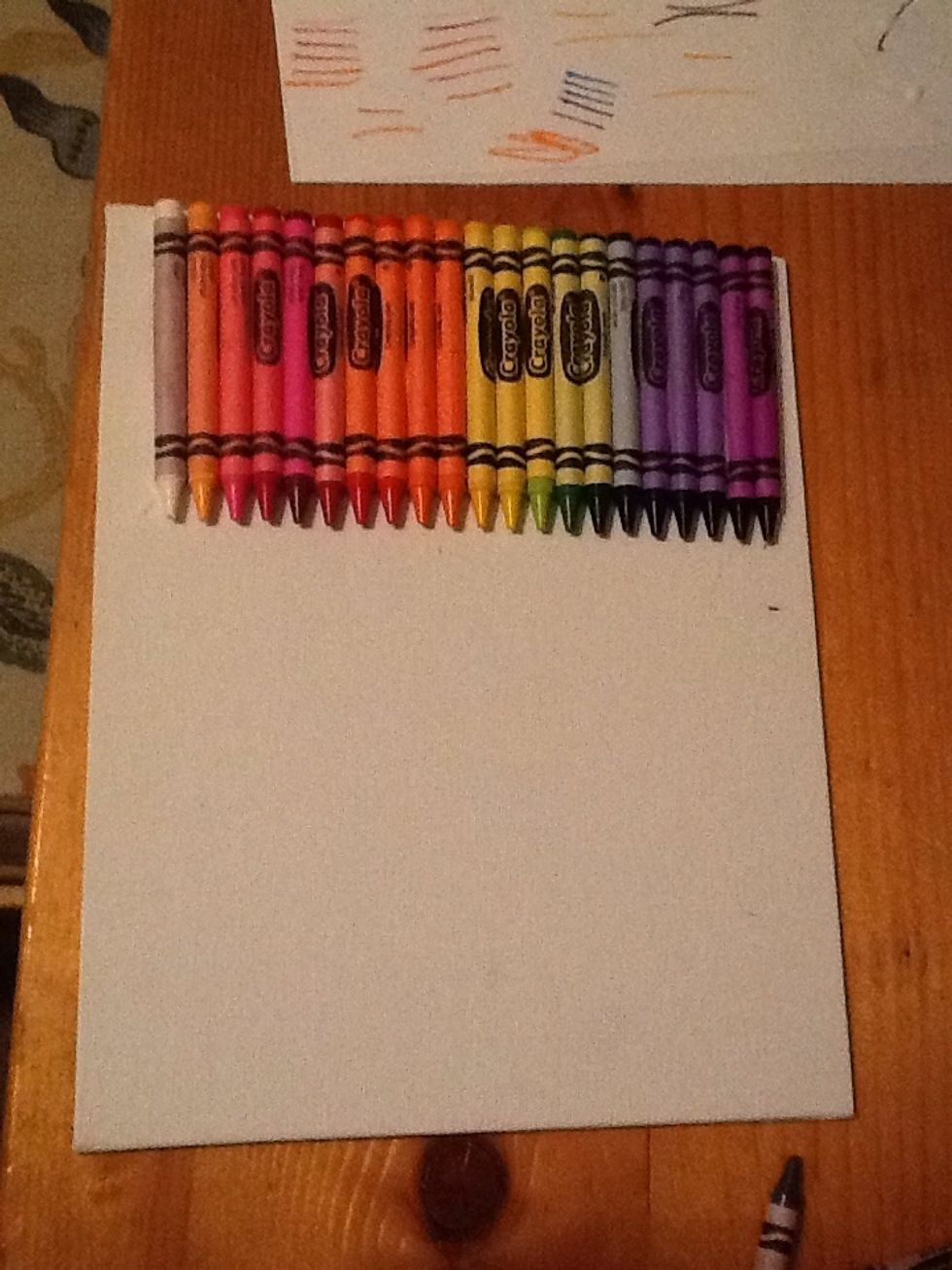 Glue the crayons on the canvas.