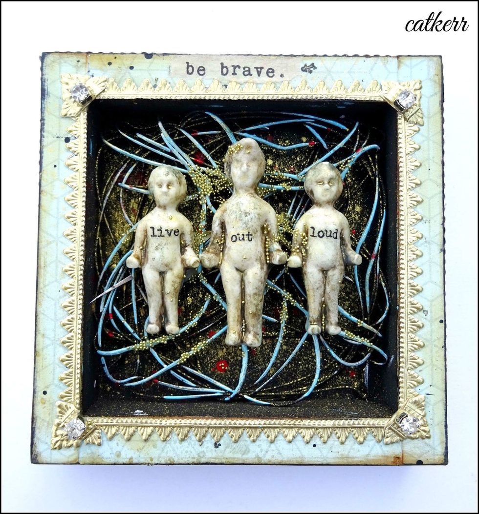 Glue the dolls in place with Tacky Glue. Add additional glue to the wire and sprinkle with micro beads.