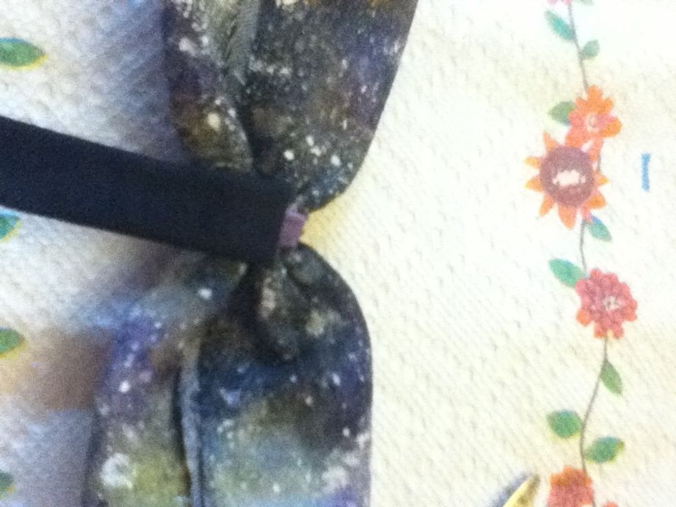 Glue the end of the strip to the back of the bow.