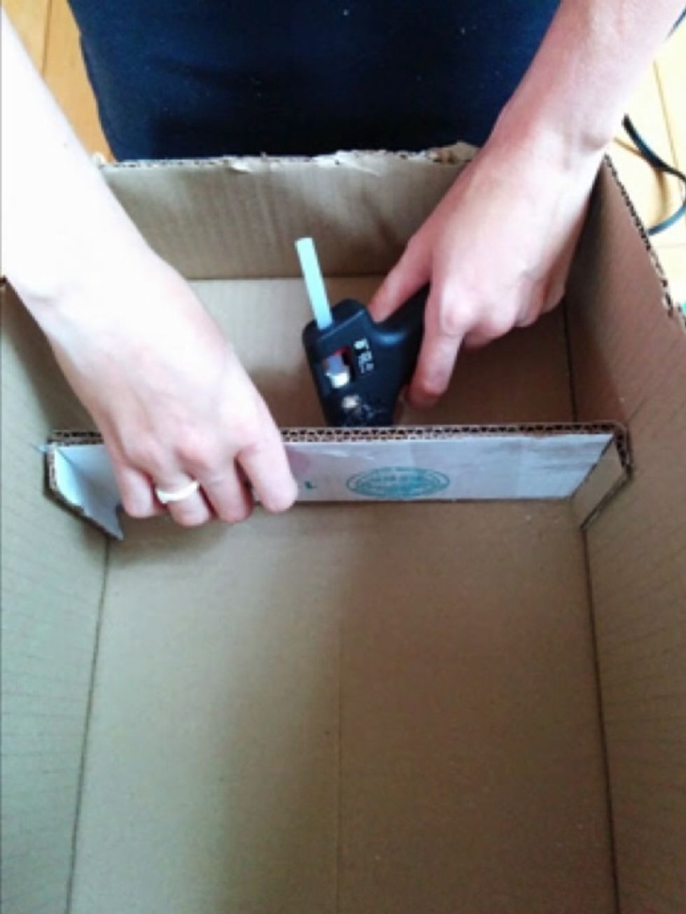 Glue the first shelf 13cm from the top of the box. Use hot glue directly on the box, as well as on the 1cm folds. Glue the next shelf 13cm down from the first. Repeat for the third shelf.