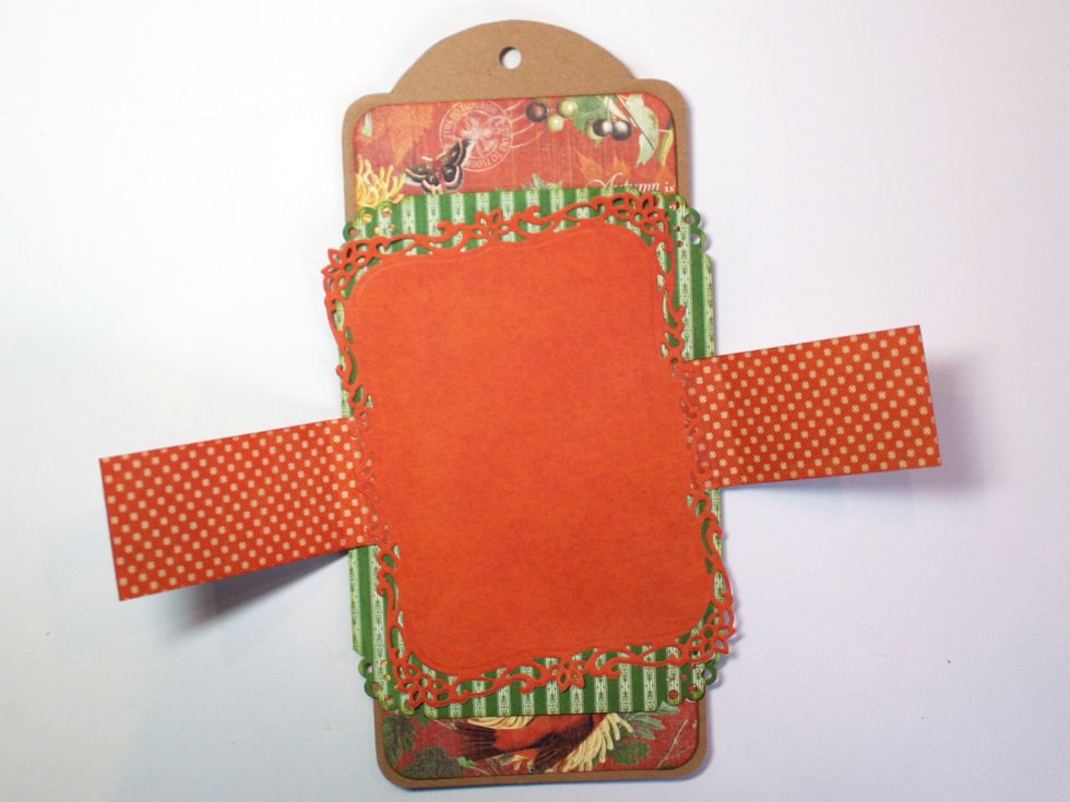 Glue the frame with the strips onto your tag tilting it a bit.