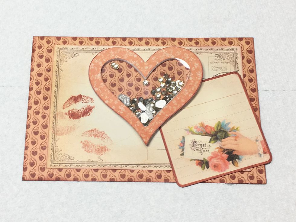 Glue the heart shaker in the center as shown and slide the tag under the heart.