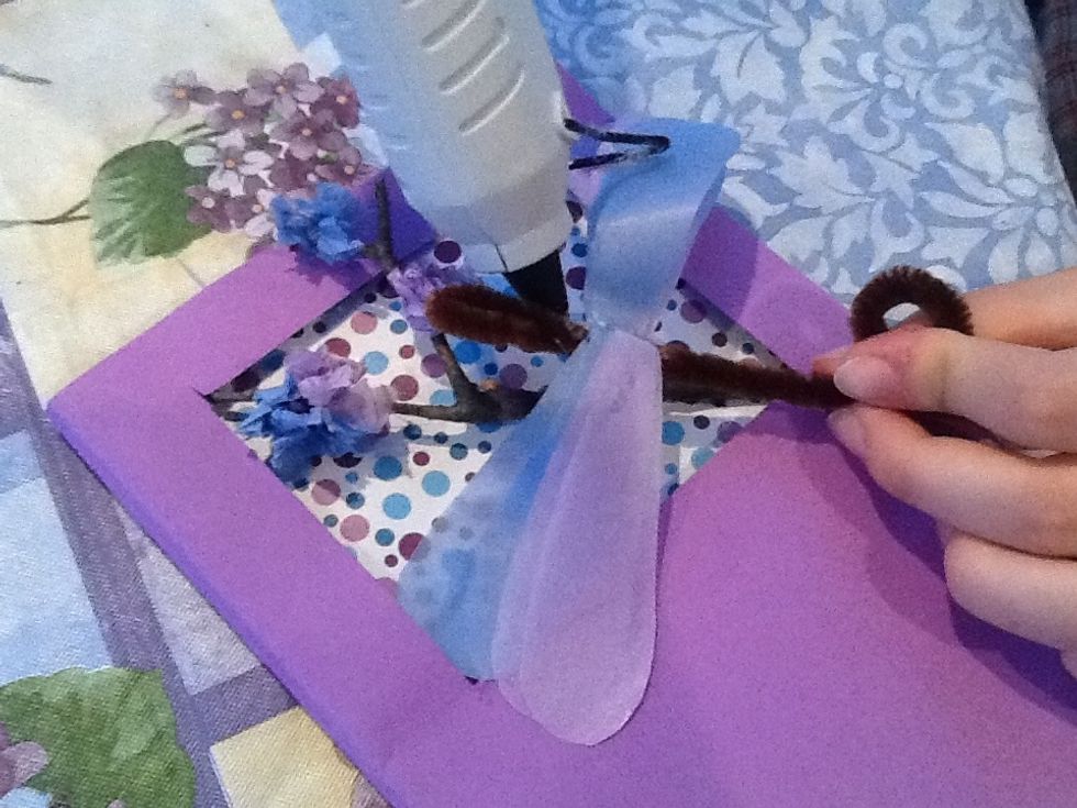 Glue the insect to the branch (don't cover the tissue buds), and glue the branch into the window of the card, sticking the ends under the first layer of paper so it looks like part of a longer branch