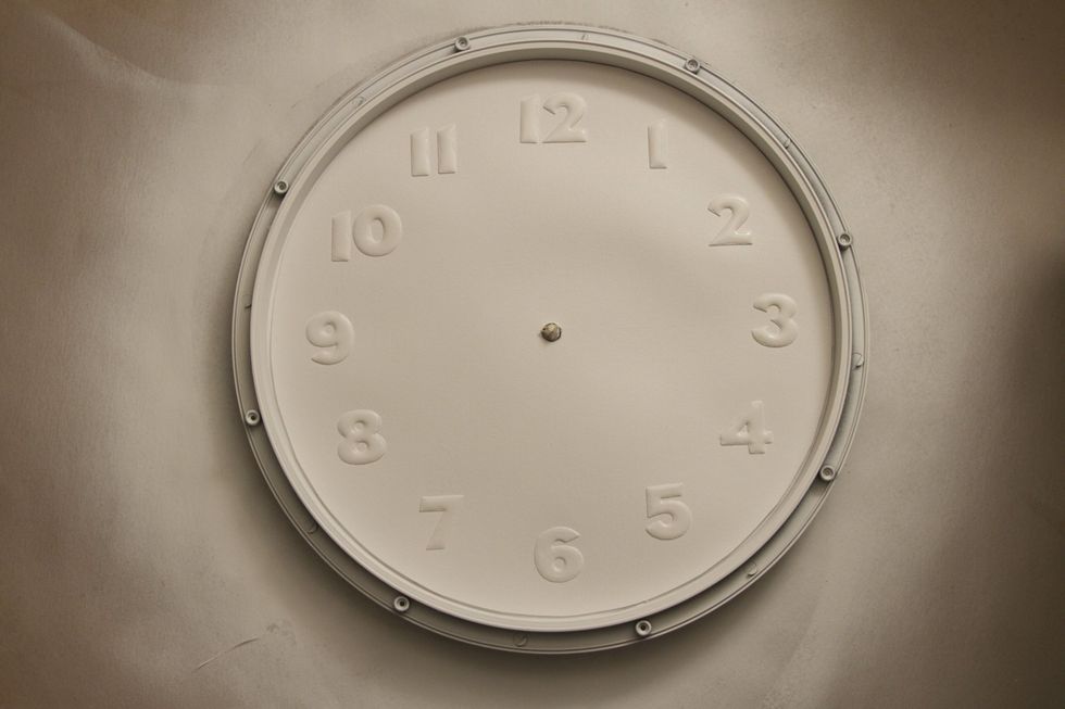 Glue the new clock face to the interior frame and spray one final coat. Reassemble the clock with the interior frame, exterior frame and glass face.