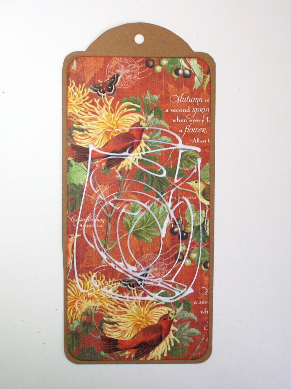 Glue the November Flourish rectangle to the base tag. (I had already applied glue for the next layer when I snapped this photo, oops!)