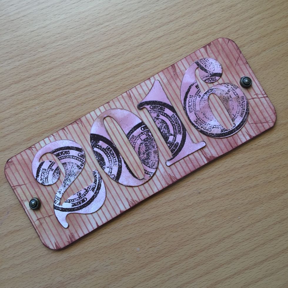 Glue the numbers and add two brads.