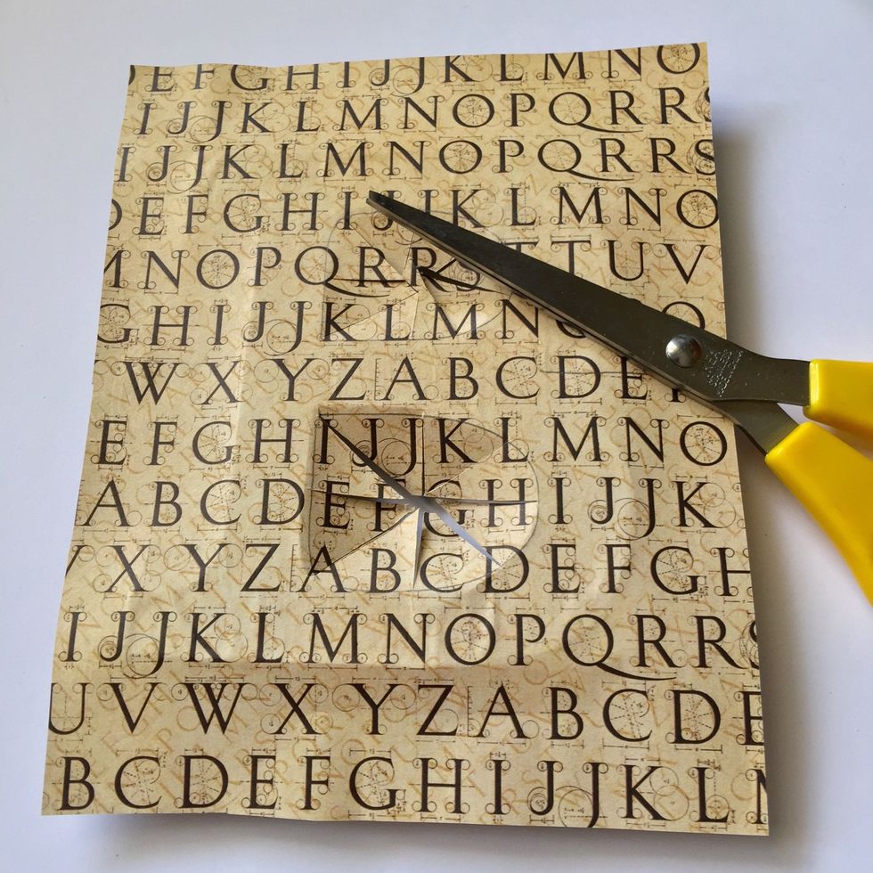 Glue the paper and cut the two holes of letter "B" as shown.