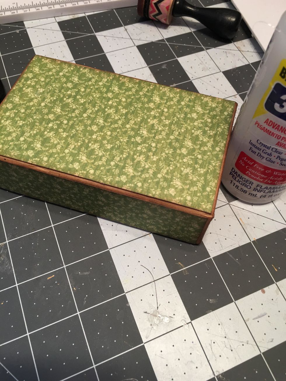 Glue the papers to the outside of the box.