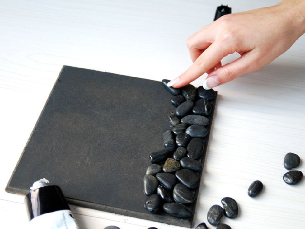 Glue the pebbles in random order while ensuring to place them next to each other and wait about two hours to dry.