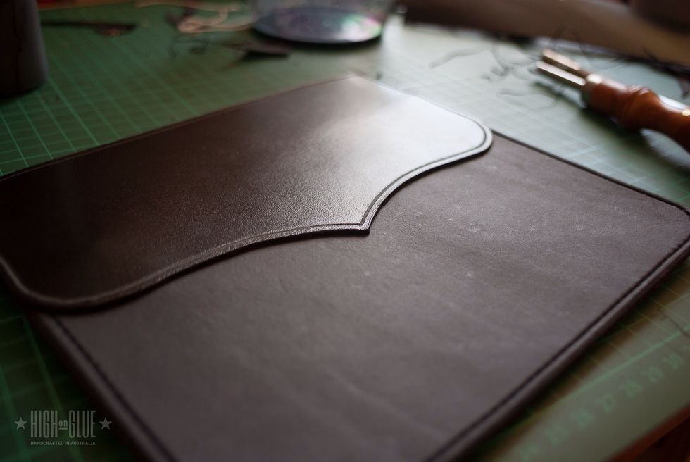 Glue the piece of leather in place. It will cover the back of the rubber band and will also help make the back cover look a bit more interesting depending on what shape you're going for.