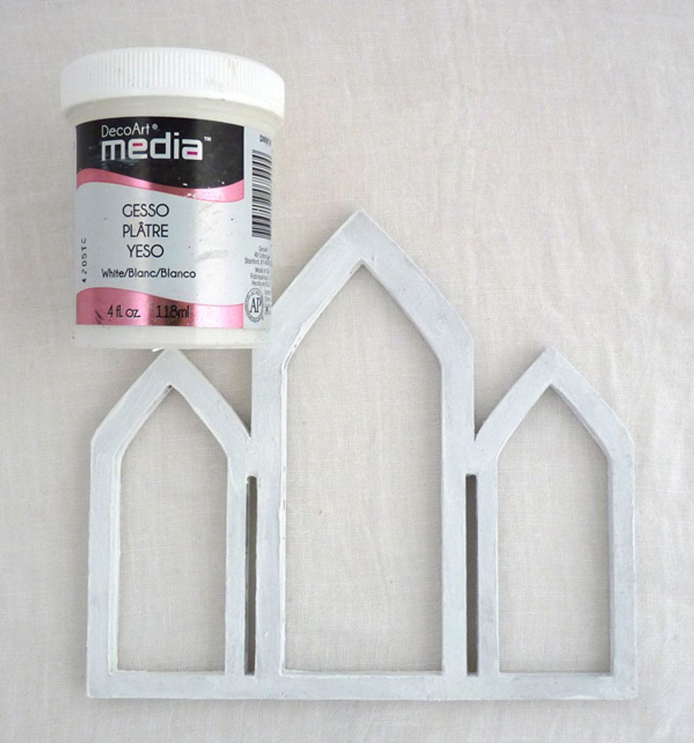 Glue the pieces of the frame together and paint it with gesso to seal the chipboard and preventing it from getting too wet with the additional layers of paint that are going to be added to it.